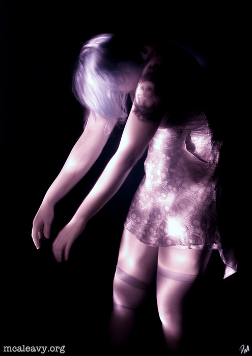 Female figure with stockings and skulls. Infrared light painted photograph.