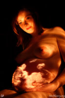 Pregnant nude with projected ultrasound. Light painted photograph.