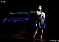 Light streaks wearing polkadot dress. Light painted fashion photograph.
